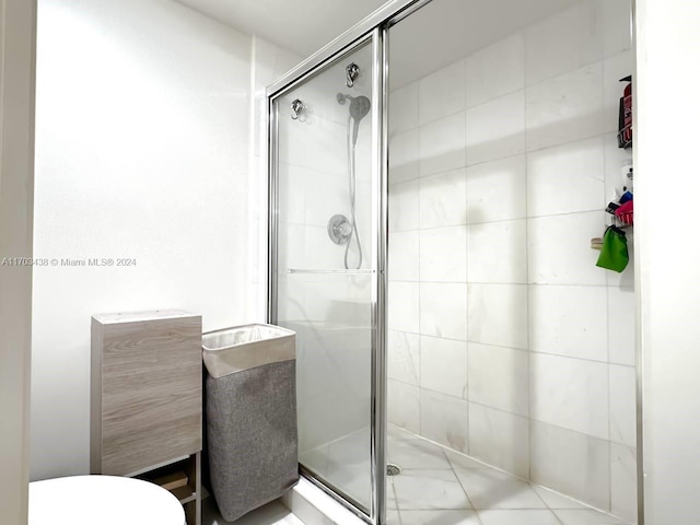 bathroom featuring a shower with door