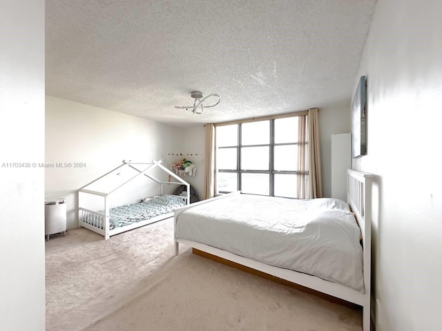 carpeted bedroom with a textured ceiling