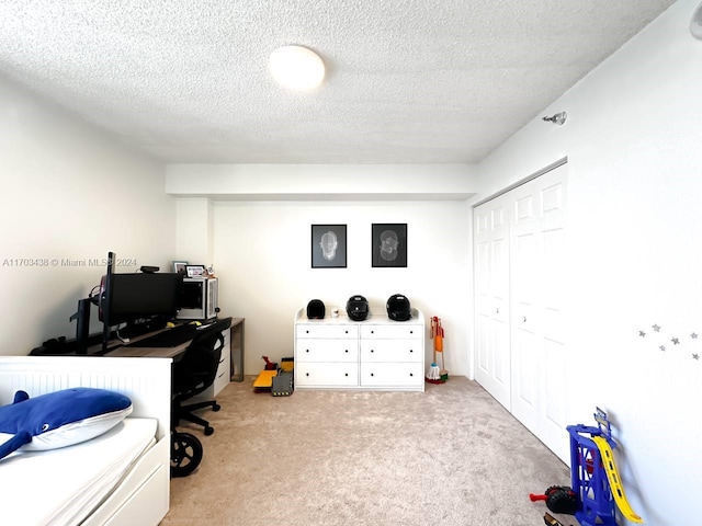 carpeted office with a textured ceiling