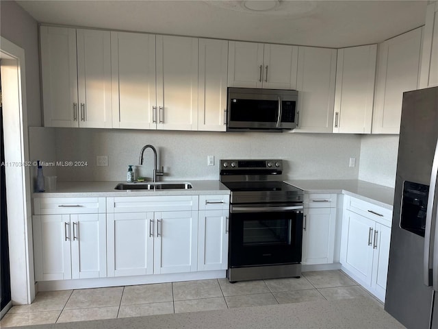 kitchen with sink, white cabinets, and stainless steel appliances