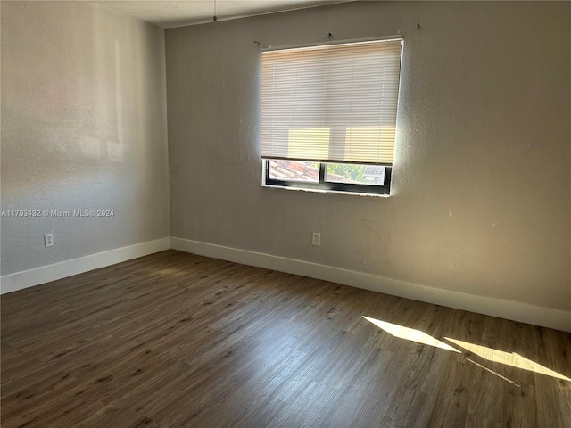 empty room with dark wood-type flooring