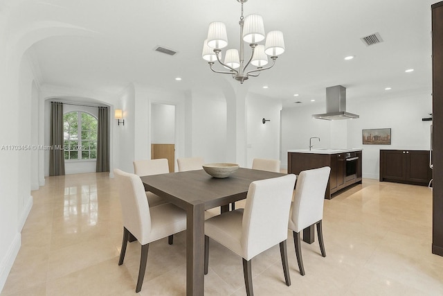 dining area featuring recessed lighting, visible vents, light tile patterned floors, arched walkways, and a chandelier