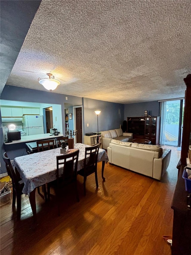 dining room featuring hardwood / wood-style floors and a textured ceiling