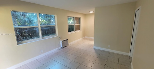 tiled empty room featuring a wall unit AC