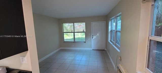 doorway to outside with light tile patterned floors