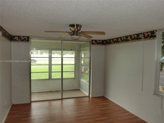 interior space with a textured ceiling, hardwood / wood-style flooring, and ceiling fan