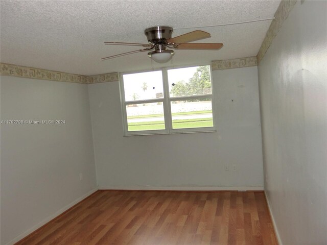 spare room featuring hardwood / wood-style floors, a textured ceiling, and ceiling fan