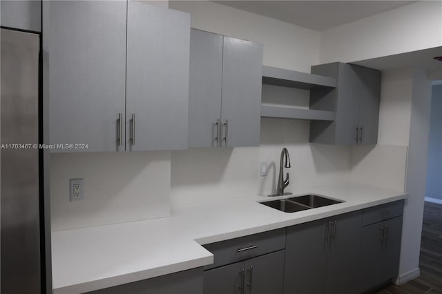 kitchen featuring dark hardwood / wood-style floors, gray cabinets, and sink