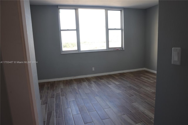 empty room with hardwood / wood-style flooring