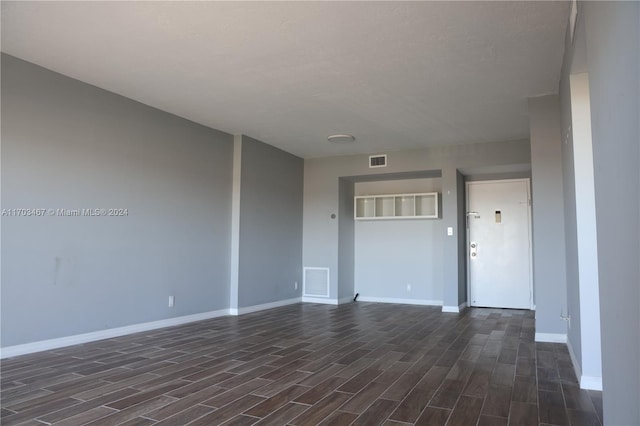 spare room with dark wood-type flooring