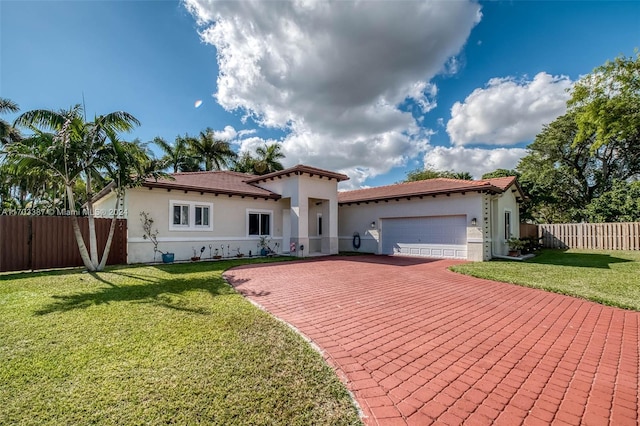 mediterranean / spanish-style house with a garage and a front yard