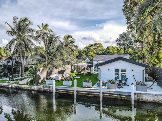 dock area with a yard and a water view