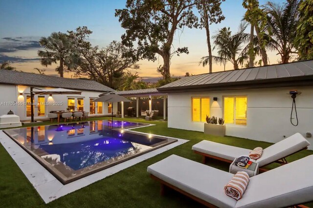 pool at dusk with a yard