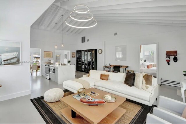 dining space with vaulted ceiling with beams