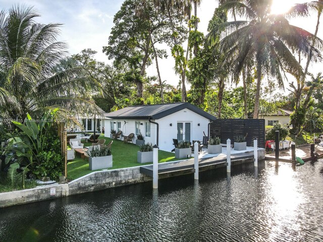 view of dock featuring a yard and a water view