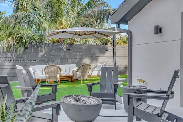 view of patio / terrace with an outdoor living space with a fire pit