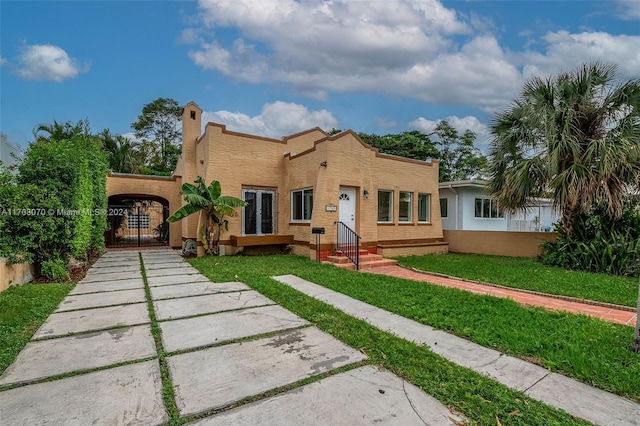 mediterranean / spanish home featuring a front yard