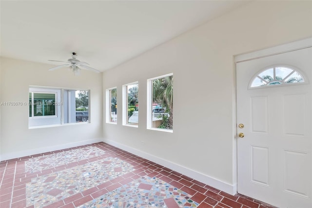 foyer entrance with ceiling fan and a healthy amount of sunlight