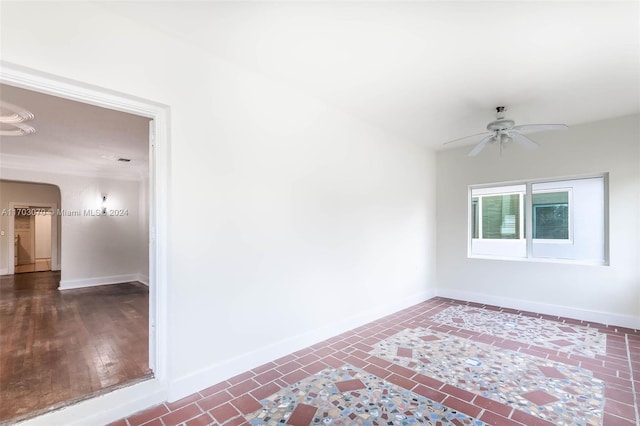 unfurnished room with dark hardwood / wood-style flooring and ceiling fan