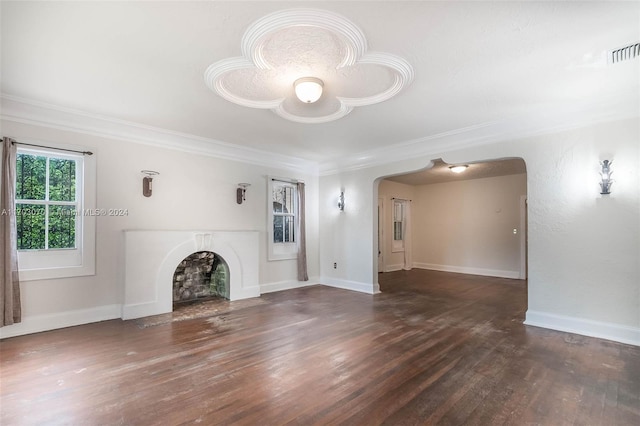 unfurnished living room featuring dark hardwood / wood-style floors and ornamental molding