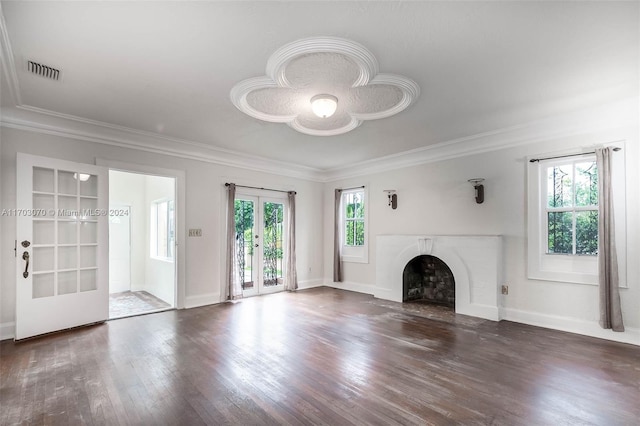 unfurnished living room featuring dark hardwood / wood-style floors, built in features, a wealth of natural light, and crown molding