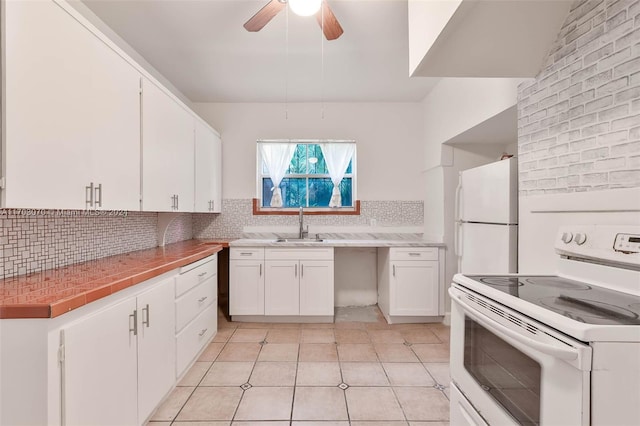 kitchen with white appliances, sink, ceiling fan, decorative backsplash, and white cabinetry