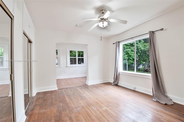 spare room with hardwood / wood-style floors and ceiling fan