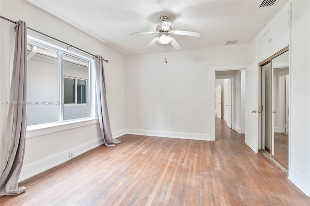 spare room with light hardwood / wood-style flooring and ceiling fan