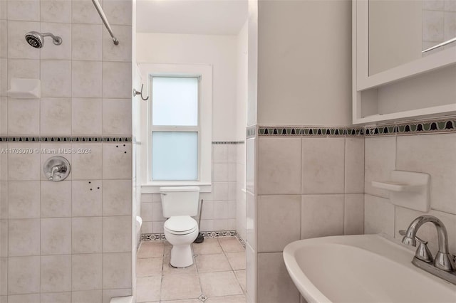 full bathroom featuring separate shower and tub, tile walls, and sink