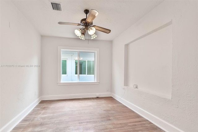 empty room featuring ceiling fan and light wood-type flooring