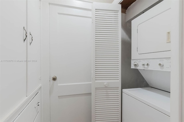 laundry area featuring stacked washing maching and dryer