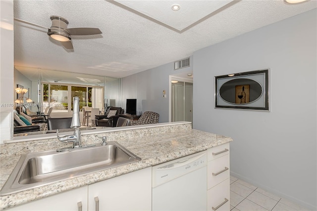 kitchen with ceiling fan, dishwasher, white cabinets, and a textured ceiling