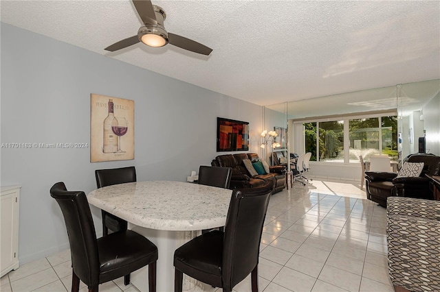 dining area with light tile patterned floors, a textured ceiling, and ceiling fan