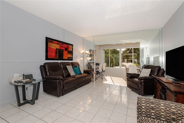 living room featuring light tile patterned floors and a textured ceiling