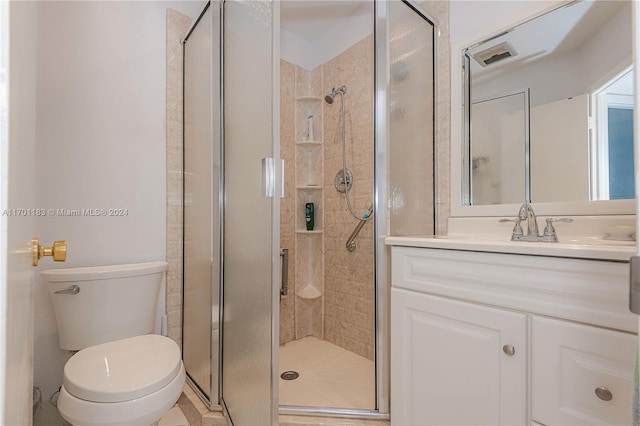 bathroom featuring an enclosed shower, vanity, and toilet