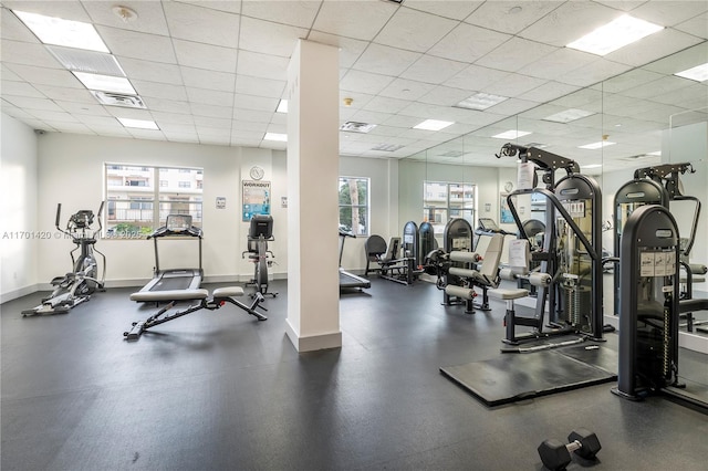 gym with a paneled ceiling