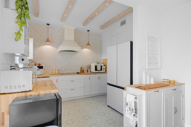 kitchen with premium range hood, white cabinetry, pendant lighting, and white appliances