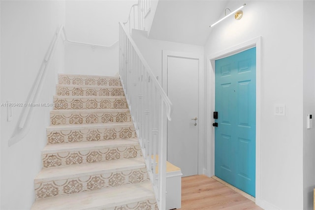 staircase featuring wood-type flooring