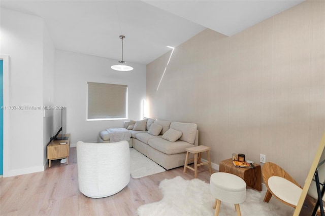 living room with hardwood / wood-style flooring and vaulted ceiling