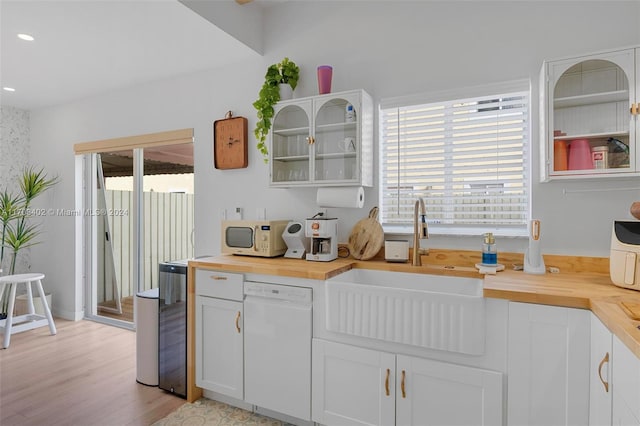 kitchen featuring light wood-type flooring, white appliances, sink, white cabinets, and butcher block counters