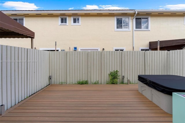 wooden terrace with a covered hot tub