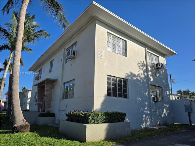 view of side of home featuring cooling unit