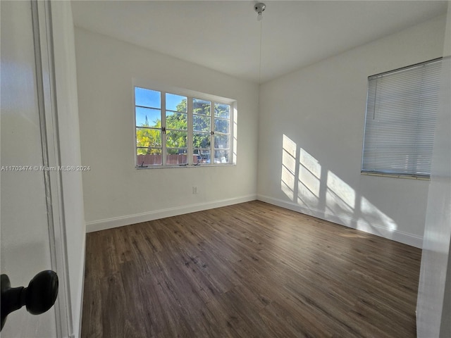 empty room featuring dark hardwood / wood-style flooring