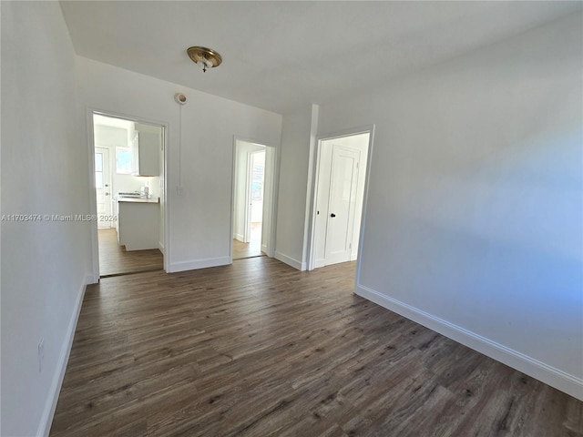 unfurnished room featuring dark hardwood / wood-style flooring