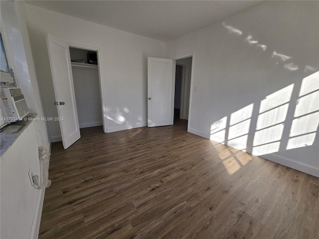 unfurnished bedroom featuring dark wood-type flooring and a closet