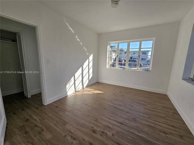 spare room featuring dark wood-type flooring