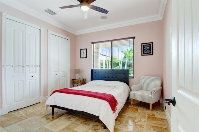 bedroom with two closets, ceiling fan, and ornamental molding