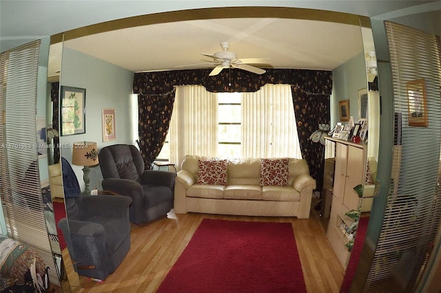 living room with ceiling fan and light hardwood / wood-style flooring