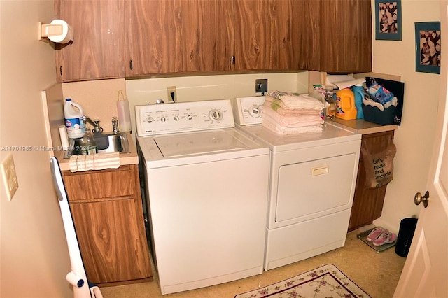 washroom with washing machine and dryer and cabinets