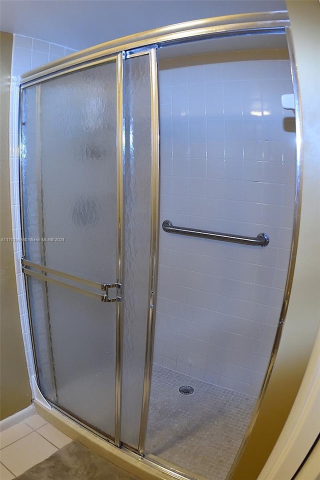 bathroom featuring tile patterned floors and an enclosed shower